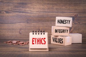 Ethics oncept. Honesty, integrity and values words. Paper boxes on wooden background